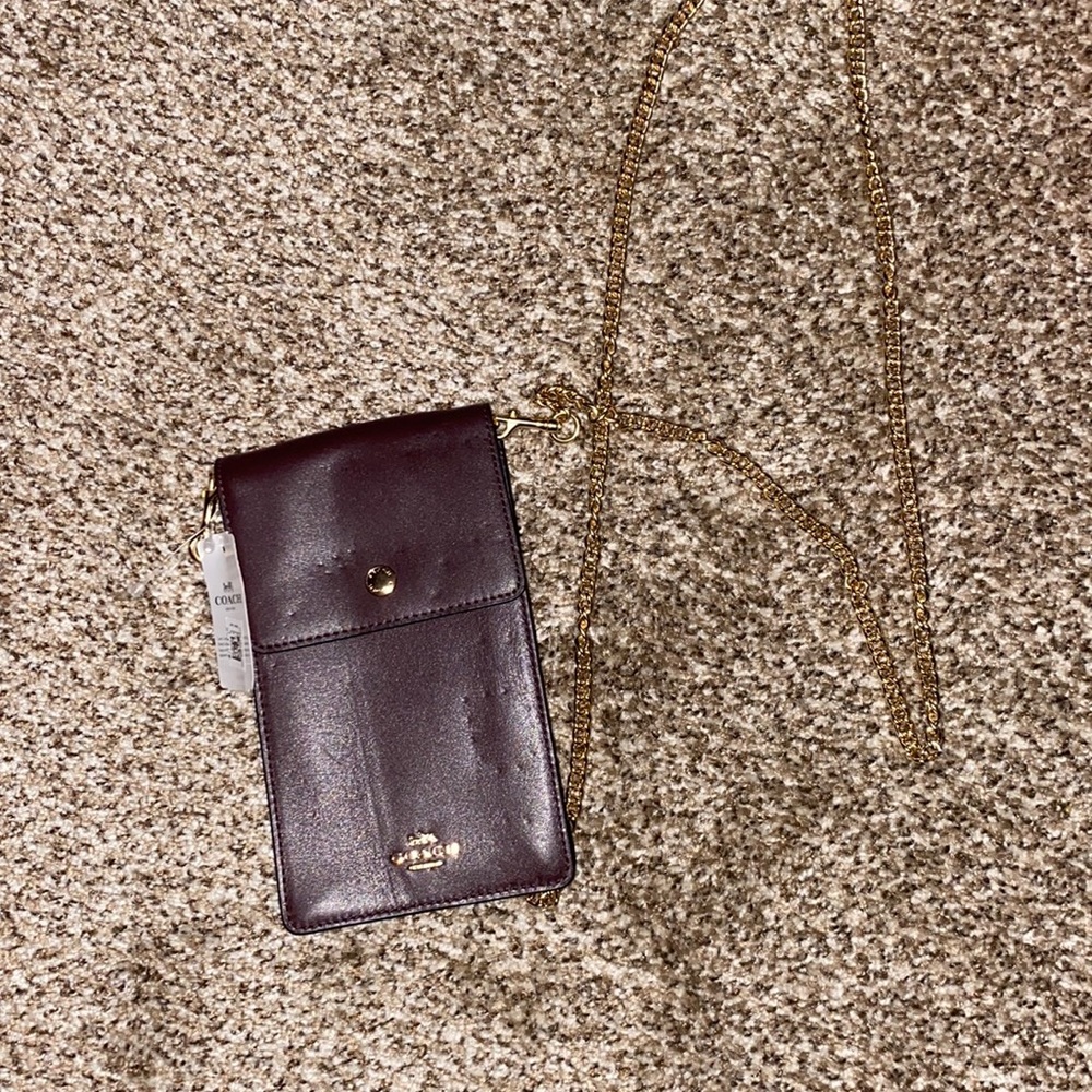 Brand new coach, cross body with credit card placement on the back.